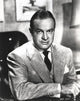 Bob Hope seated in formal suit portrait photo print