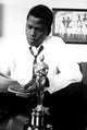 Sidney Poitier reading a newspaper with an Oscars statuette photo print