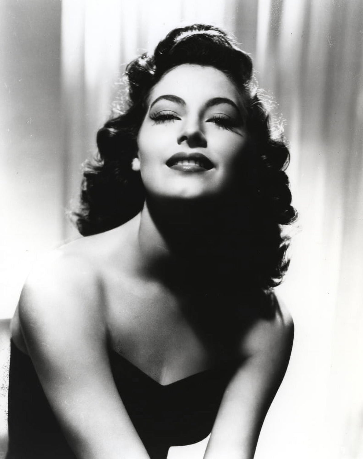 Black and white portrait of Ava Gardner in elegant black dress