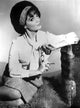 Portrait photo print of Connie Francis in a kneeling pose wearing white long sleeves.