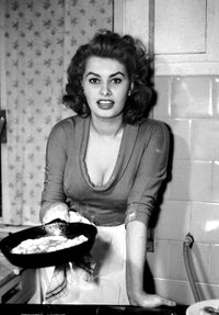 Photo print of Sophia Loren cooking an omelette in a kitchen setting.