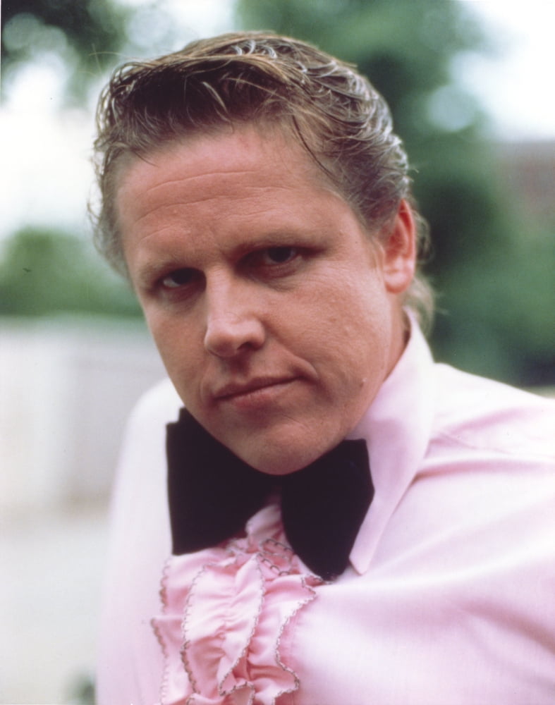 Close-up portrait photo print of Gary Busey in long sleeves with ribbon.