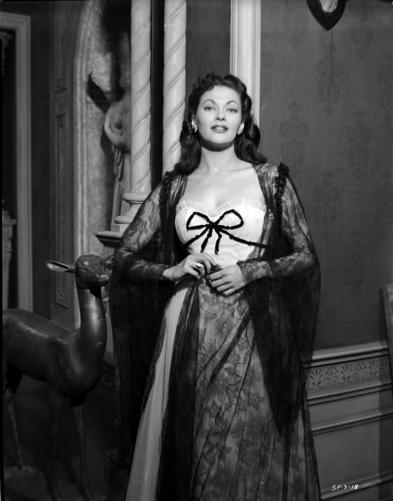 Yvonne DeCarlo standing in classic gown with white corset photo print.
