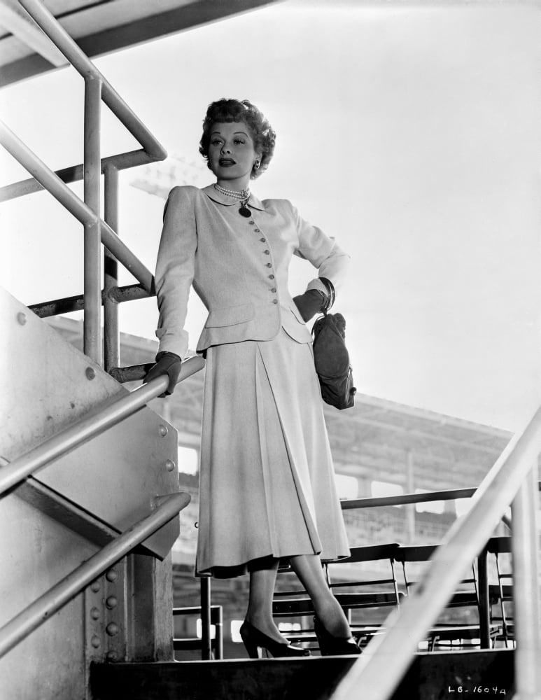 Lucille Ball standing on staircase wearing a white dress photo print