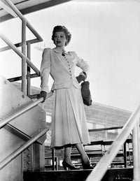 Lucille Ball standing on staircase wearing a white dress photo print