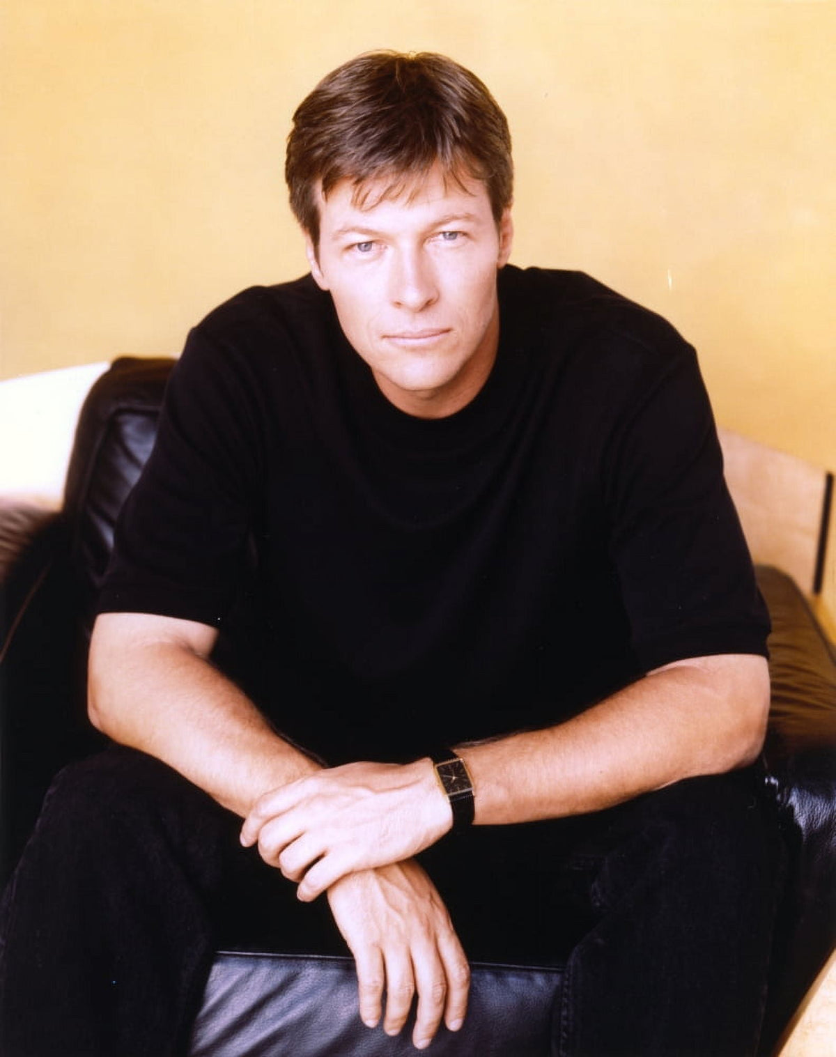 Jack Wagner sitting on a couch in a black shirt photo print.