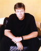 Jack Wagner sitting on a couch in a black shirt photo print.