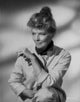 Katharine Hepburn posed in a white coat with her dog photo print