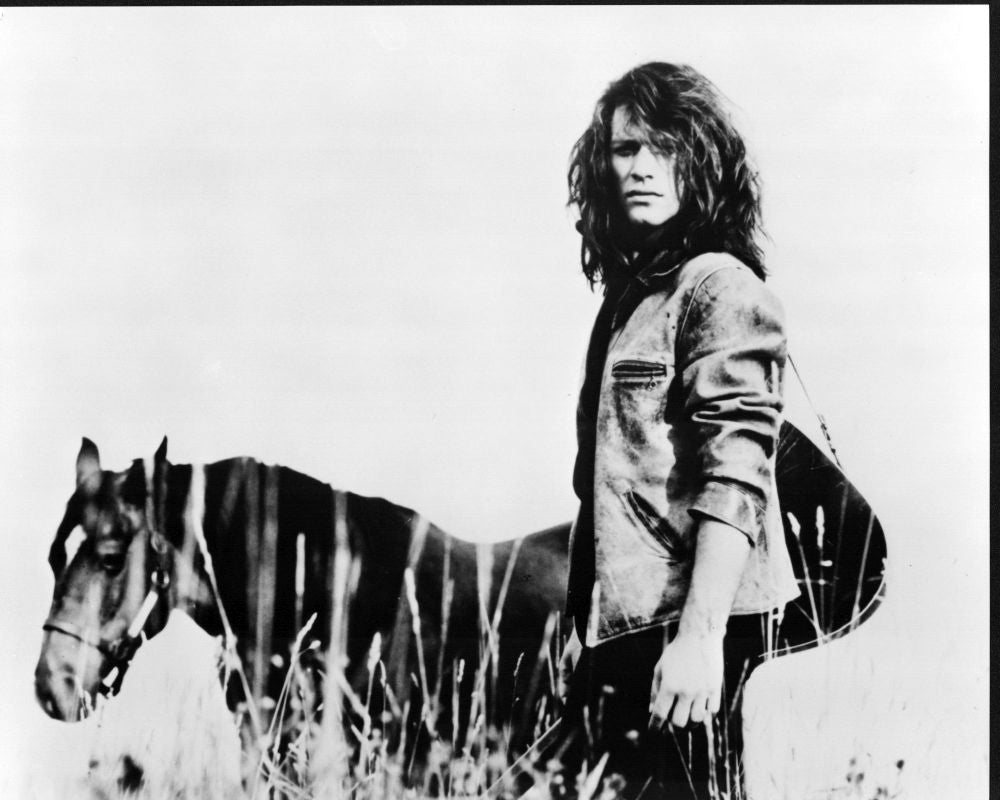 Jon Bon Jovi black and white photo print with guitar and horse in field.