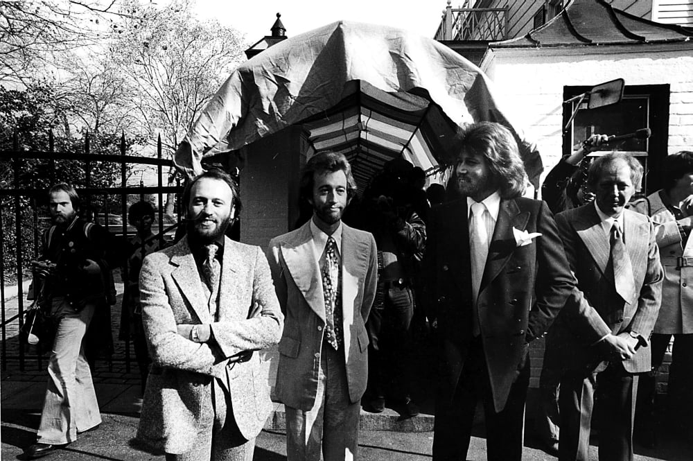 Bee Gees photo print at a mansion, capturing the iconic trio.