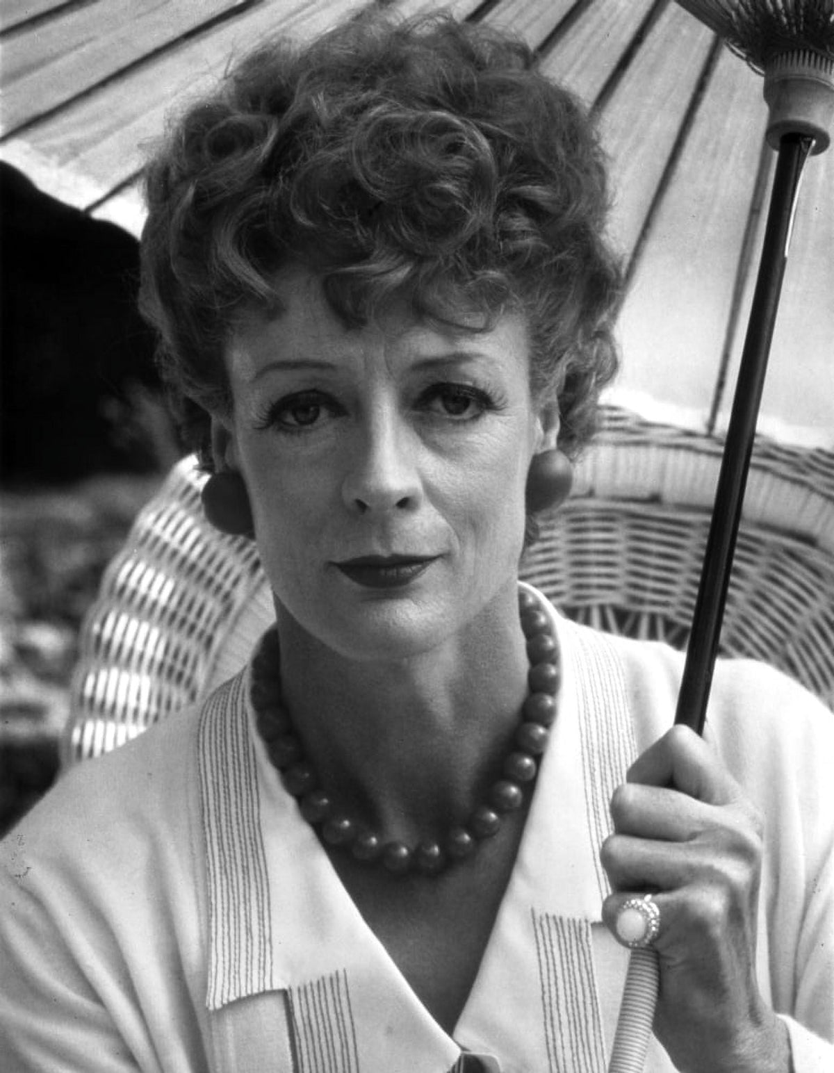 Maggie Smith holding an umbrella in white dress photo print.