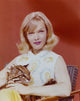 Anne Francis portrait photo print with baby leopard on red background.