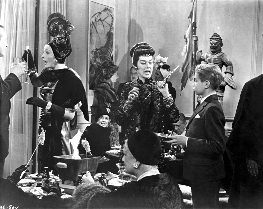 Rosalind Russell engaging in a conversation with a boy in suit photo print.