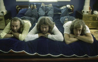 The Bee Gees lying on a bed photo print