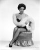Kathryn Grayson sitting on a chair with a furry shawl - Photo Print