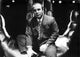 Bob Hoskins wearing a suit in a hand sculpture photo print.