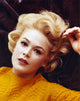 Close-up portrait photo print of Sandra Dee on a black background.