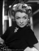 Constance Bennett portrait photo print in turtle neck top with brooch.