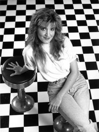 Classic photo print of Crystal Bernard in a seated pose.