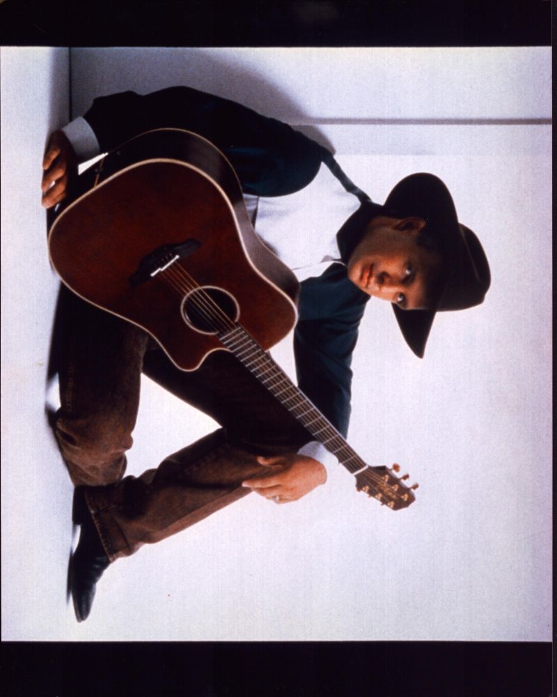 Garth Brooks Sitting on Floor with Guitar Photo Print