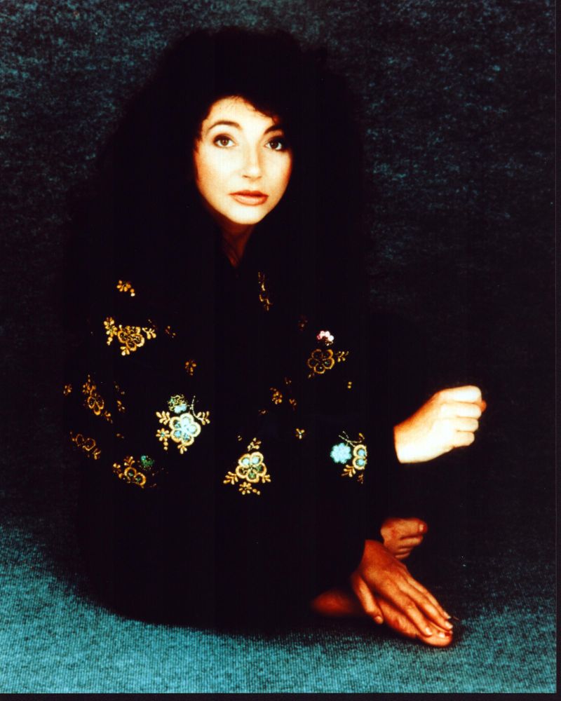 Kate Bush sitting in black and gold jacket photo print.