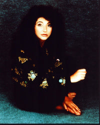 Kate Bush sitting in black and gold jacket photo print.