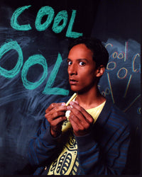 Danny Pudi Community TV show photo print in front of chalkboard.