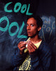 Danny Pudi Community TV show photo print in front of chalkboard.