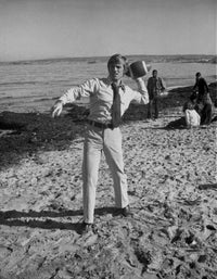 Robert Redford playing football at the beach photo print.
