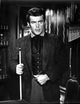 Film still photo print of Robert Conrad carrying a pool cue.