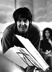 Paul McCartney standing behind a music stand photo print.