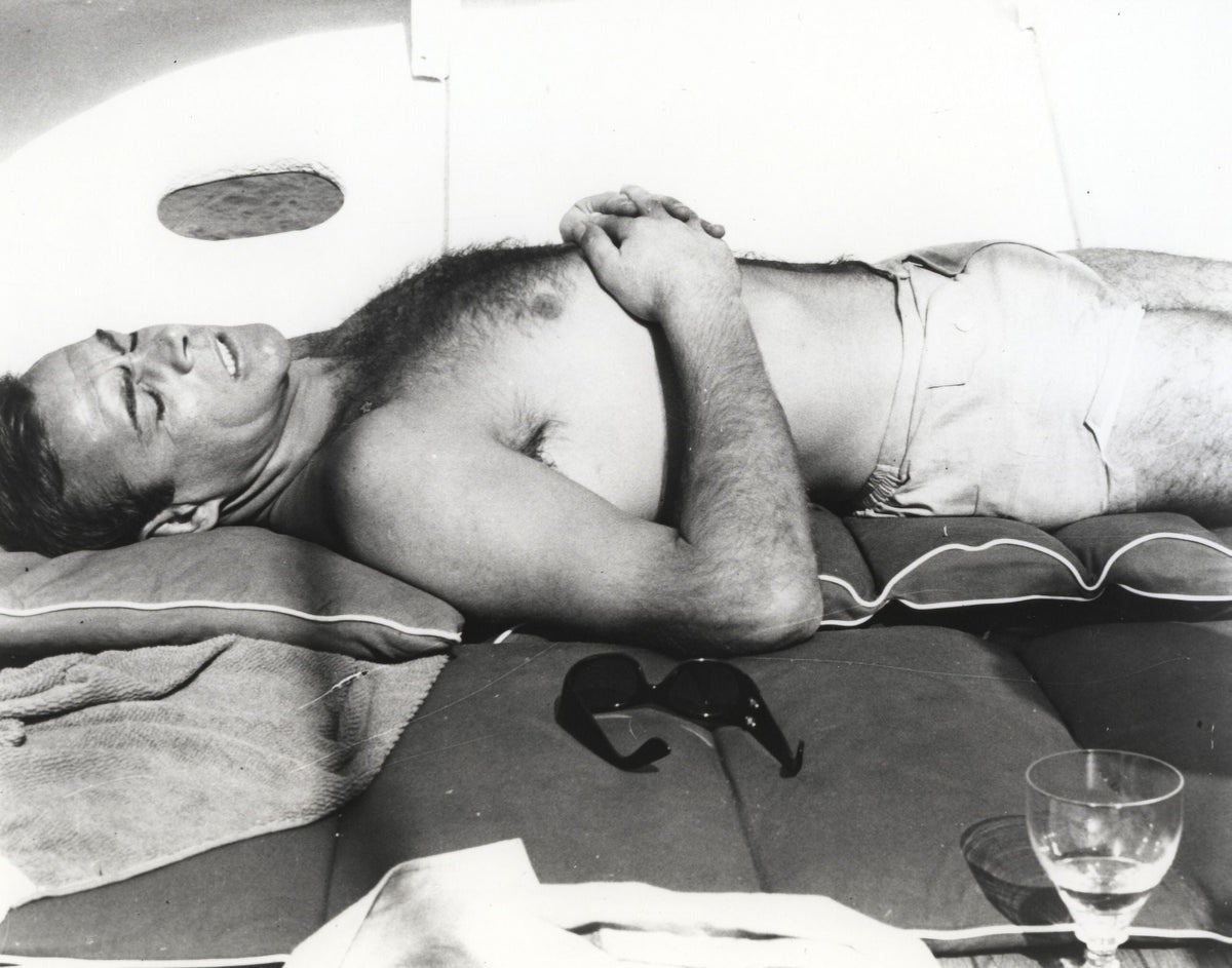 Sean Connery sunbathing on a boat photo print.