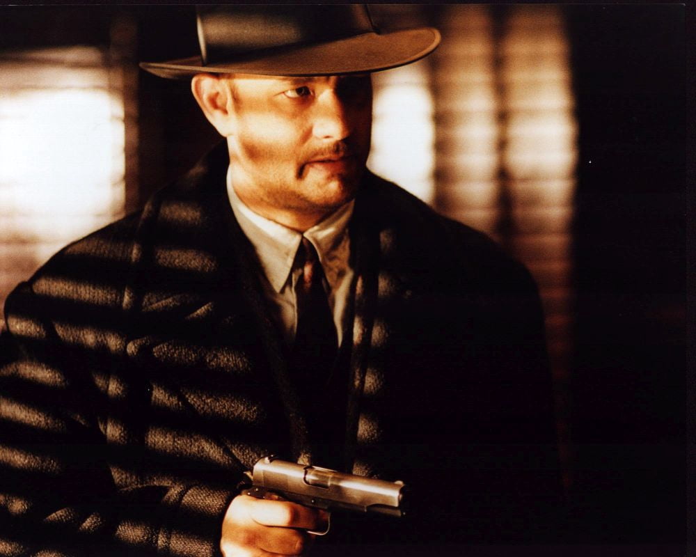 Tom Hanks holding gun on set of Road to Perdition photo print.