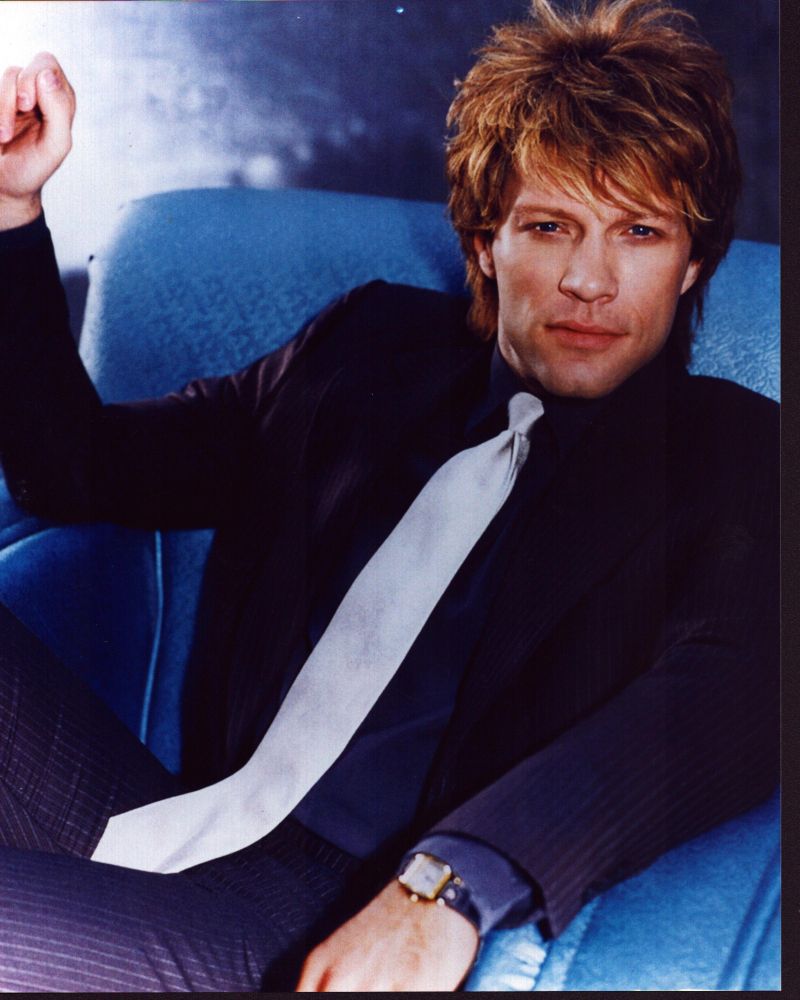 Jon Bon Jovi sitting in a suit and tie photo print.