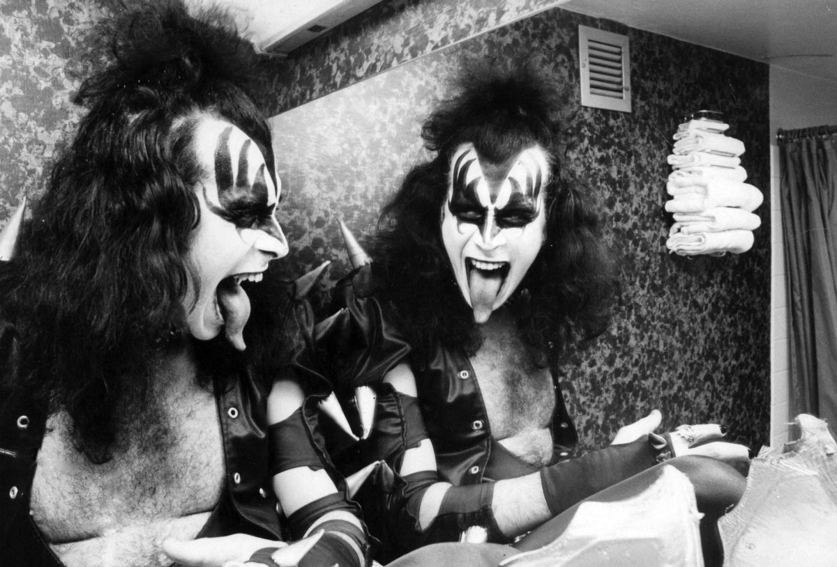 Gene Simmons sticking out his tongue by a bathroom mirror photo print