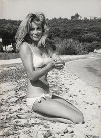 Catherine Deneuve kneeling on the beach photo print