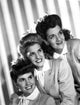The Andrews Sisters smiling in a classic group photo print.
