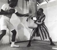 Muhammad Ali training with a boxing bag photo print