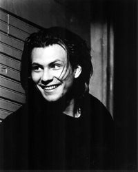 Christian Slater smiling black and white photo print leaning against wall