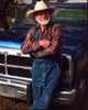Willie Nelson leaning on truck in overalls photo print.