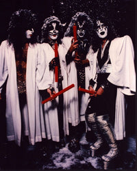Kiss band photo print in white robes with red candles.