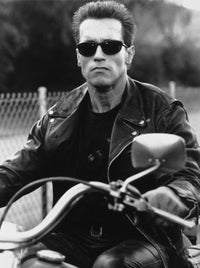 Arnold Schwarzenegger riding a bike in a black leather jacket photo print