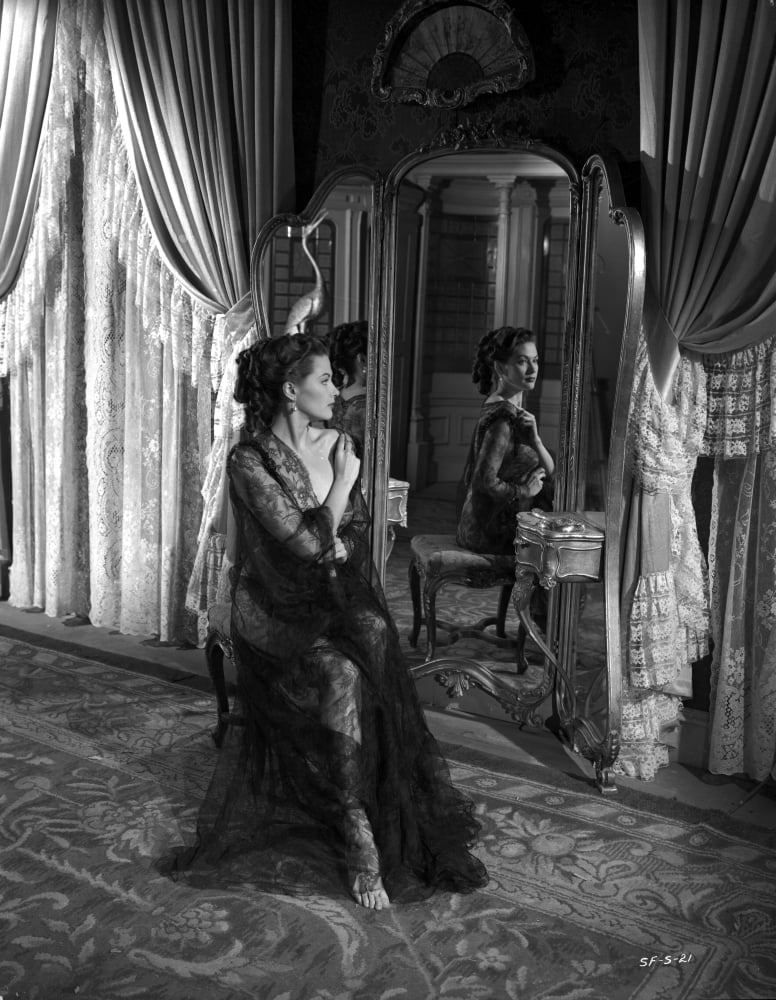 Yvonne DeCarlo looking behind in elegant black dress - black and white photo print.