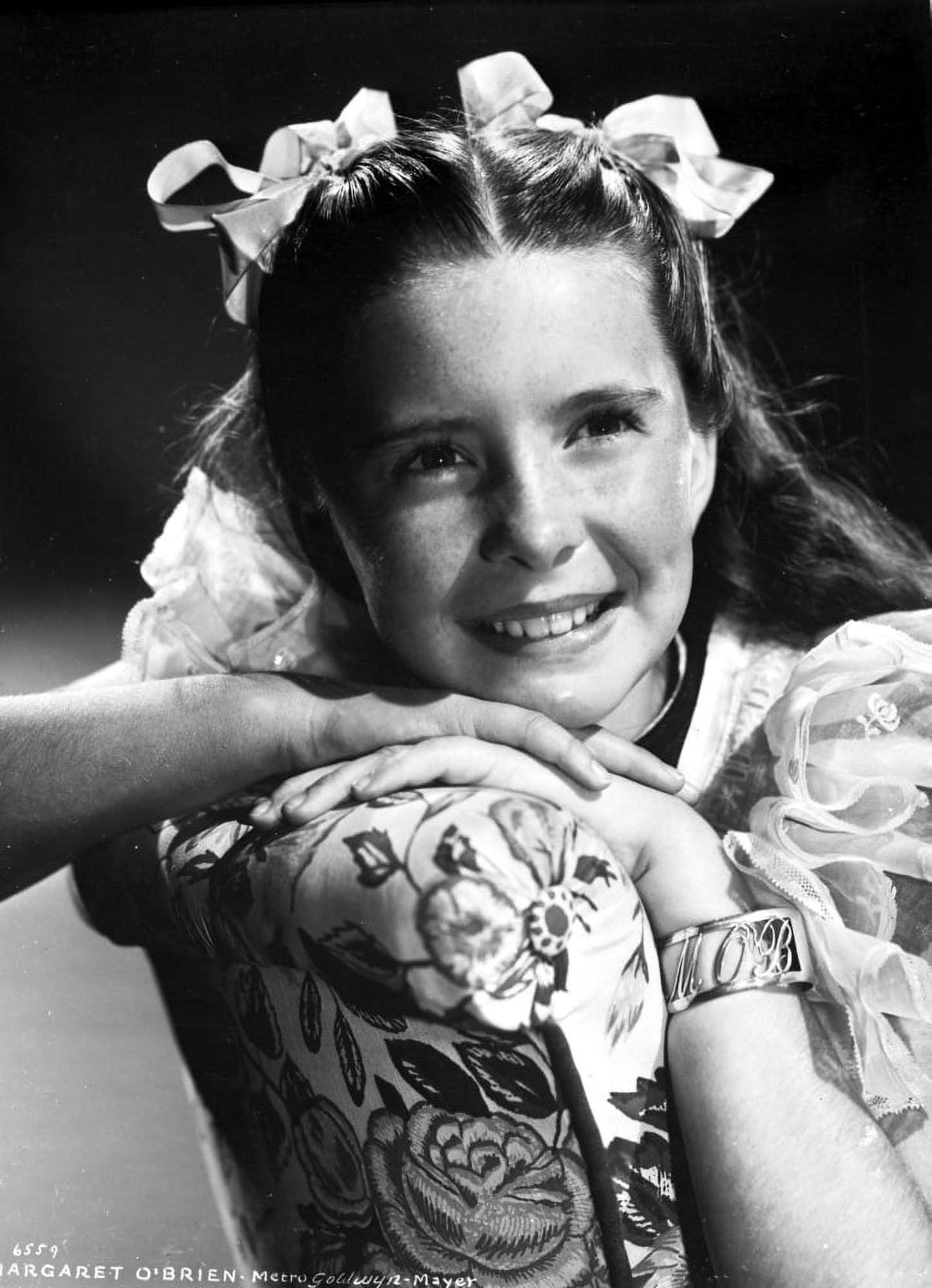 Margaret O'Brien smiling photo print on lace sleeve