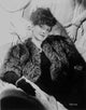 Bette Davis glamorous photo print in black fur coat and dress with black gloves.