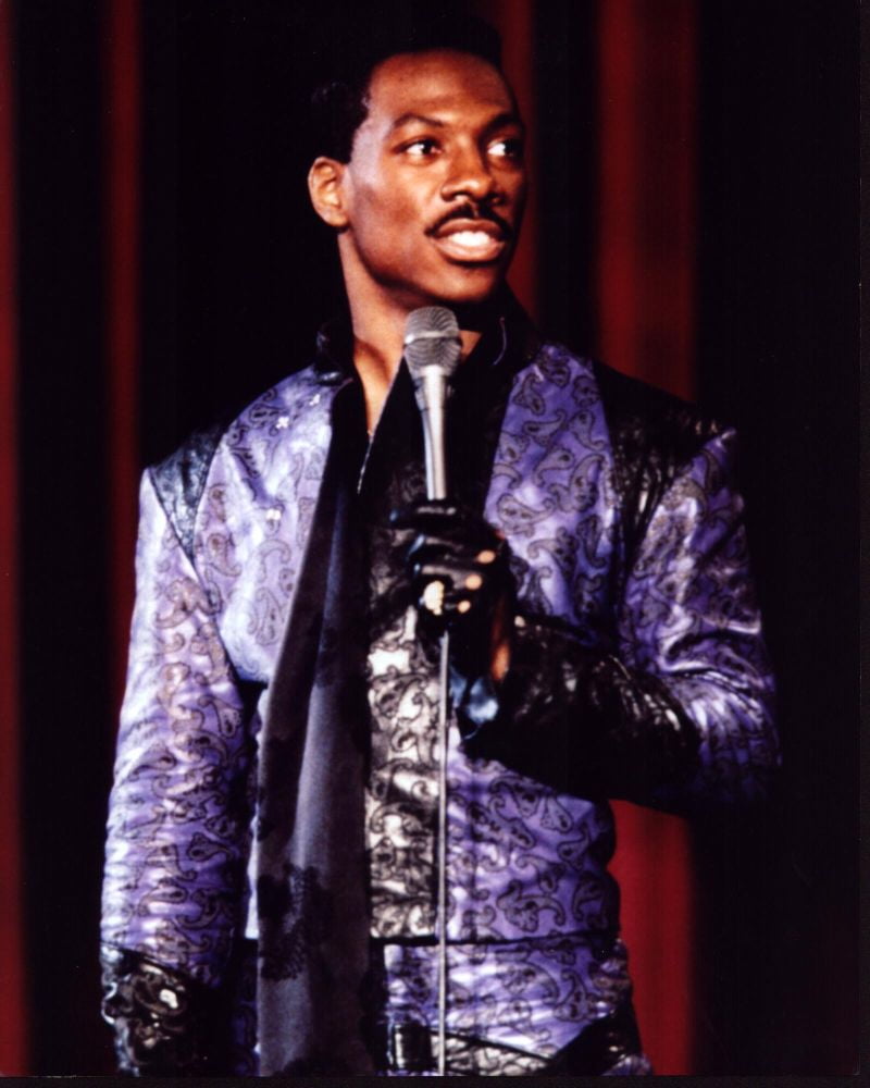 Eddie Murphy wearing a purple leather suit in a photo print.