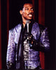 Eddie Murphy wearing a purple leather suit in a photo print.