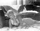 Kim Novak lying beside a sofa photo print, classic Hollywood vintage photography.
