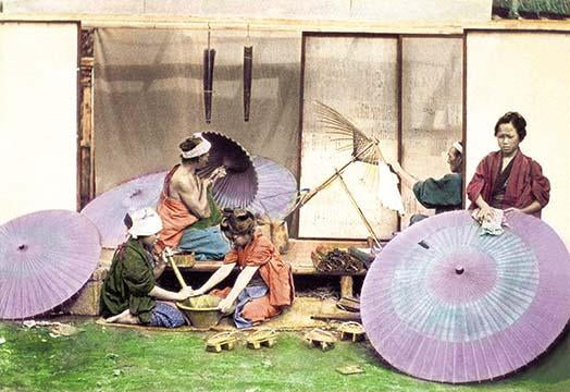 Hand-tinted Meiji era photograph of Japanese parasol manufacturing.