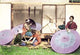 Hand-tinted Meiji era photograph of Japanese parasol manufacturing.